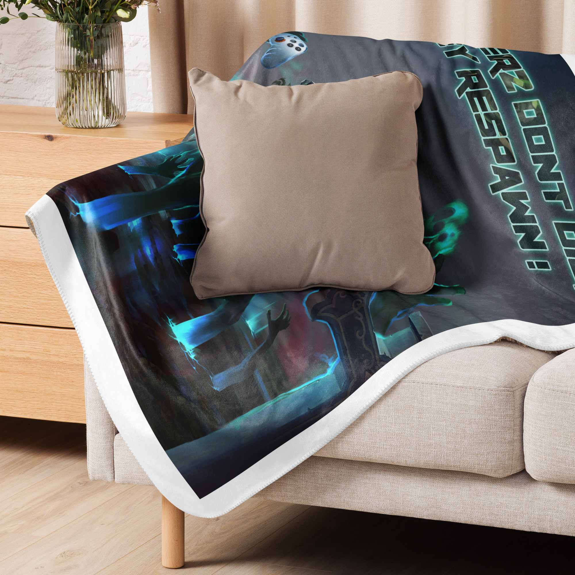 Cozy Gamers Respawn Point Sherpa blanket draped over a sofa, showcasing plush texture and vibrant gaming-themed design.