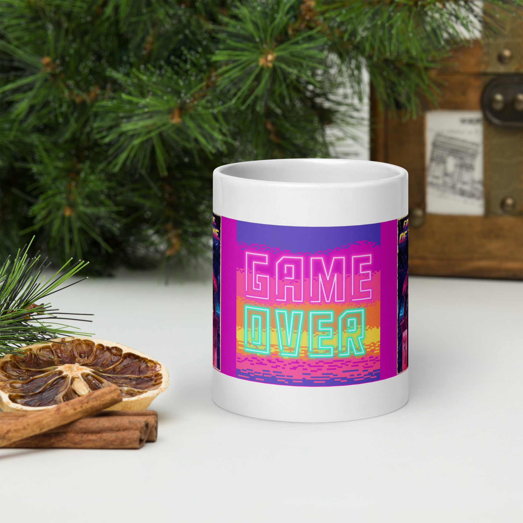 Ceramic mug with "Game Over" text, vivid colors, next to pine branches and dried orange slice, perfect for coffee or tea.